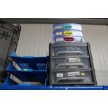 A three tier filing tray and two banks of three dr