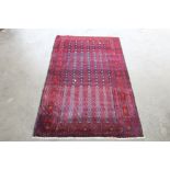 An approx. 6'2" x 3'6" Eastern red patterned rug