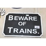 A cast iron 'Beware of Trains' sign