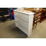 A white painted open fronted bookcase
