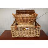 A wicker hamper and various basket ware
