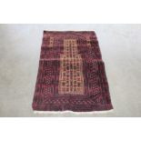 An approx. 4'8" x 2'10" Eastern red patterned rug