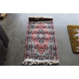 An approx. 4' x 2' modern patterned rug