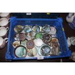 A basket of various glass paperweights including t
