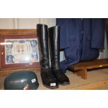 A pair of vintage black leather riding boots