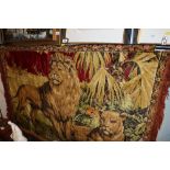 A wall hanging depicting lion, lioness and cubs