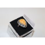 A white metal and yellow stone set ring