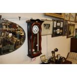 An 8 day wall clock in mahogany case