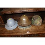 Three WWII home front helmets and one other