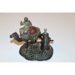 A cold painted spelter camel and Arab strike light