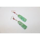 A pair of carved jade type drop ear-rings