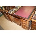 An oak twin pedestal desk fitted eight drawers, la