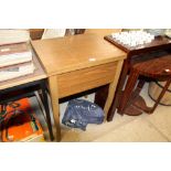 A sewing machine in fitted table case