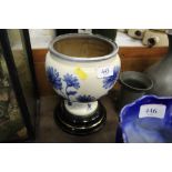 A heavy blue and white floral decorated ceramic ur