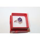 A sterling silver and amethyst set dress ring, siz