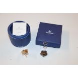 Two boxed Swarovski items, a Labrador puppy and ph