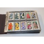A cigarette card album and contents of various pla