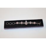 A silver and rose quartz set bracelet