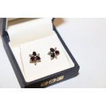 A pair of silver and garnet set ear-rings