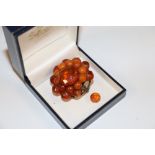 A facet cut toffee amber base metal set brooch