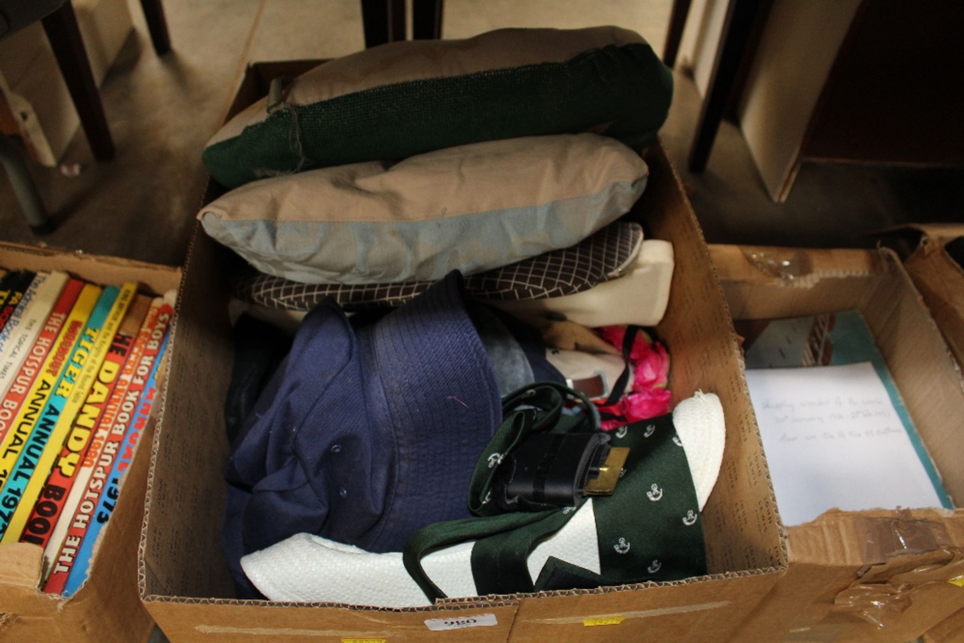 A box of various hats; cushions etc