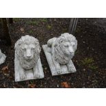 A pair of concrete garden ornaments in the form of