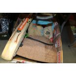 A box of various bags and a cricket bat