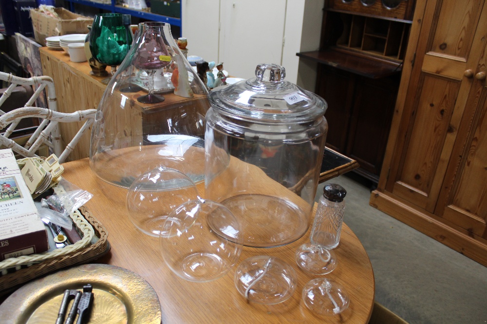 A large glass vase; storage jars and glass oil can