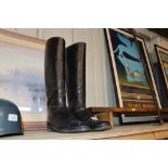 A pair of vintage black leather riding boots