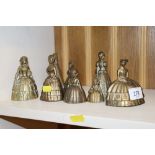 A collection of brass crinoline lady bells