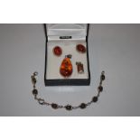 A collection of silver mounted and amber jewellery