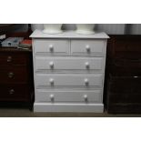 A modern white painted chest fitted two short over