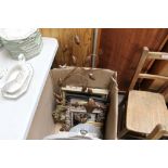 A box containing modern wall clocks, prints and fr