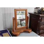 A stained pine swing frame mirror