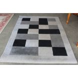 An approx. 7'2" x 5'4" modern patterned rug