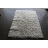 An approx. 5'10" x 4'1" modern rug