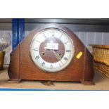 An oak cased two hole mantel clock