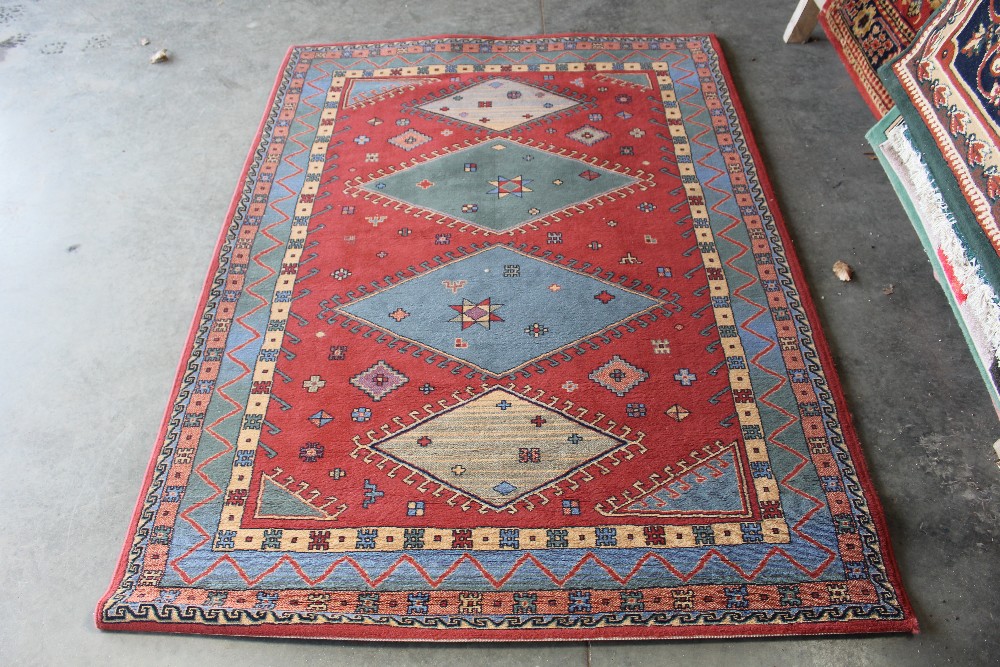 An approx. 6'8" x 4'8" red patterned rug