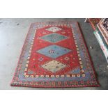 An approx. 6'8" x 4'8" red patterned rug