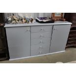 A modern grey sideboard fitted five central drawer