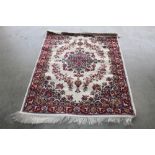 An approx. 4'7" x 4' red patterned rug