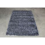 An approx. 5'7" x 4' modern rug