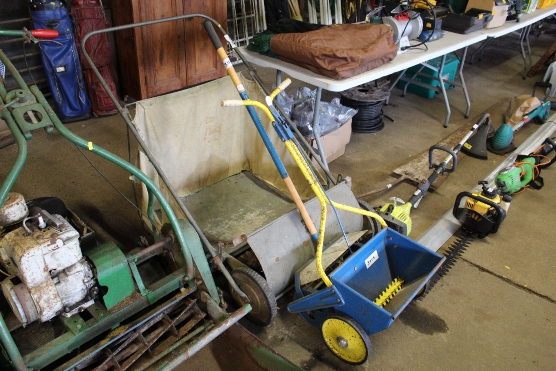 A lawn sweep; scarifier and seed spreader