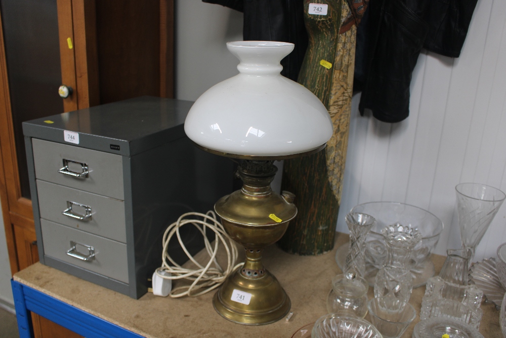 A brass oil lamp and shade converted to electricit