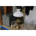 A brass oil lamp and shade converted to electricit