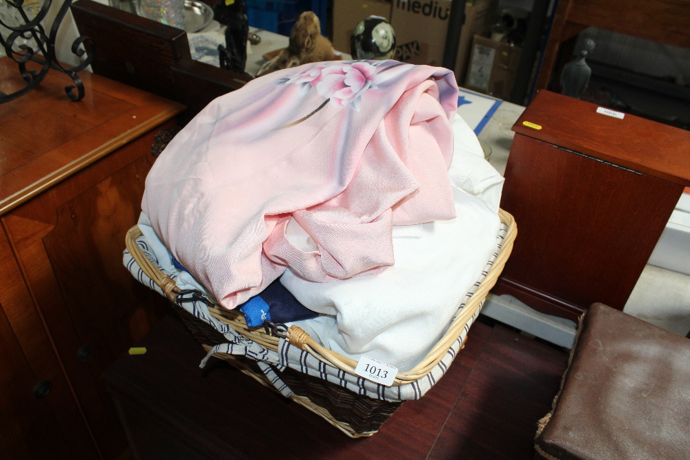 A wicker basket and contents of various linen