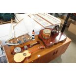 A children's guitar, barometer, model boat, biscui