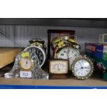 A collection alarm clocks and a mantel clock