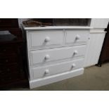A modern white painted chest fitted two short over