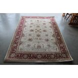 An approx. 7'6" x 5'3" red patterned rug